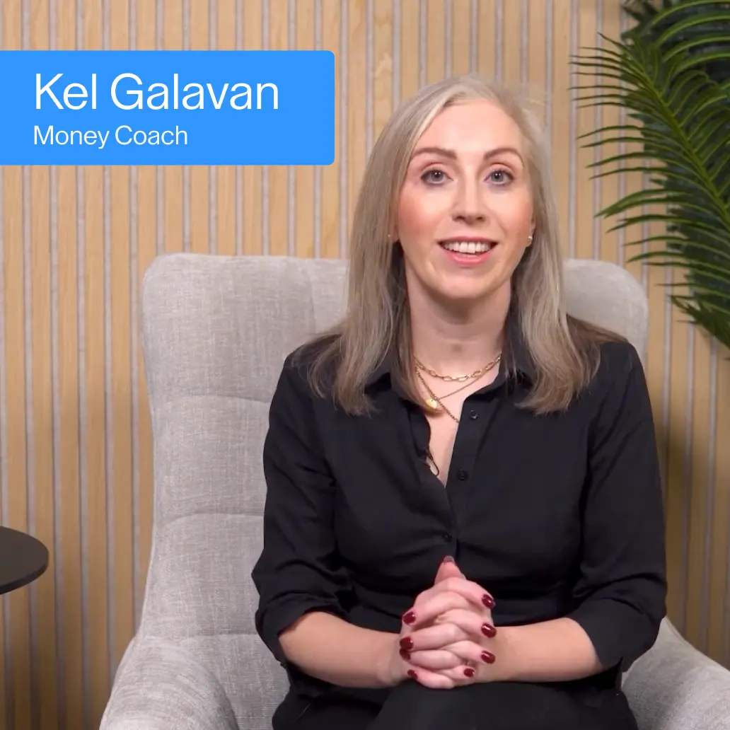 raisin_ie_kel_galavan.png Kel Galavan, Money Coach, seated in a chair against a wood panel backdrop, smiling at camera.